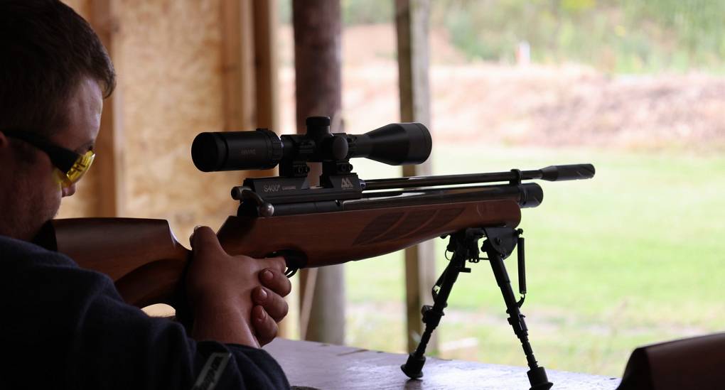 Stag taking aim with an Air Rifle at the range