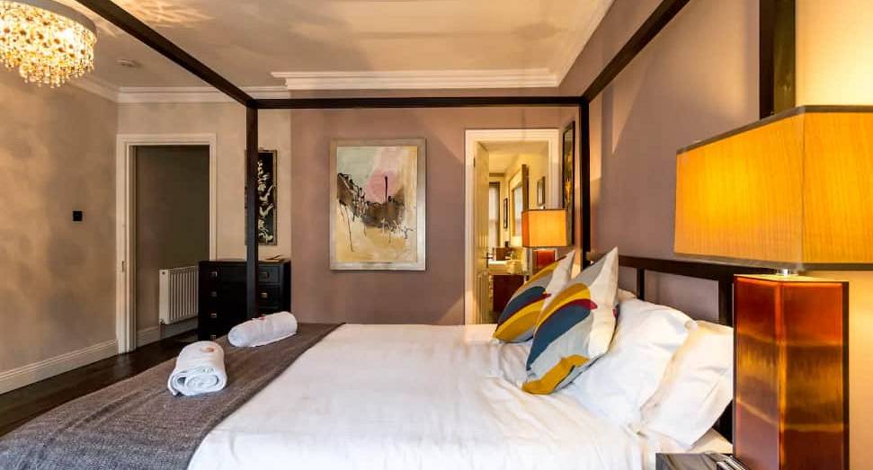 Four-poster double bed and ensuite access at the Bournemouth Hot Tub Garden hen party house.