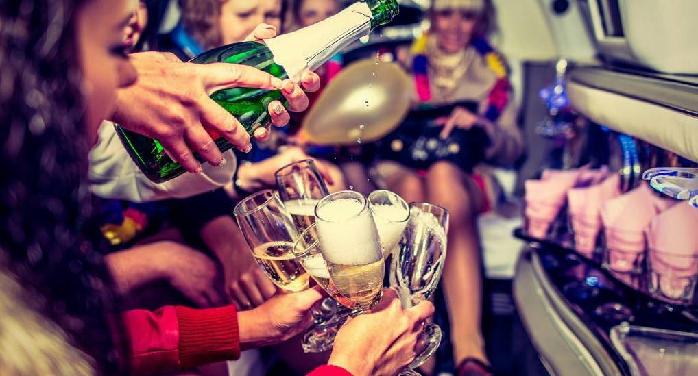 Hen party in limo enjoying a glass of bubbly