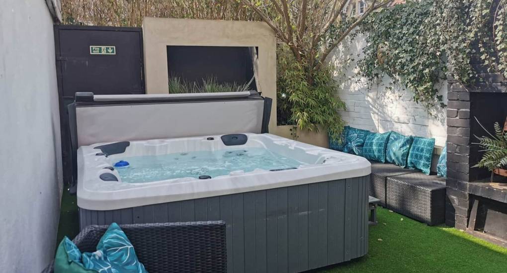 The private courtyard oasis and hot tub at the Bournemouth Hot Tub Garden hen party house.