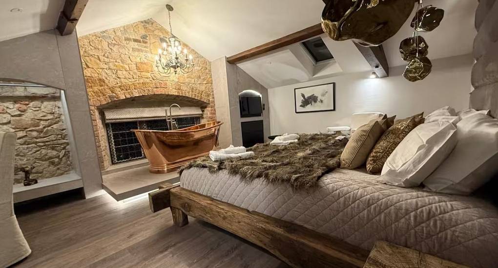 Luxury hen party house Chester bedroom at House of Dreams with a modern double bed and feature lighting.