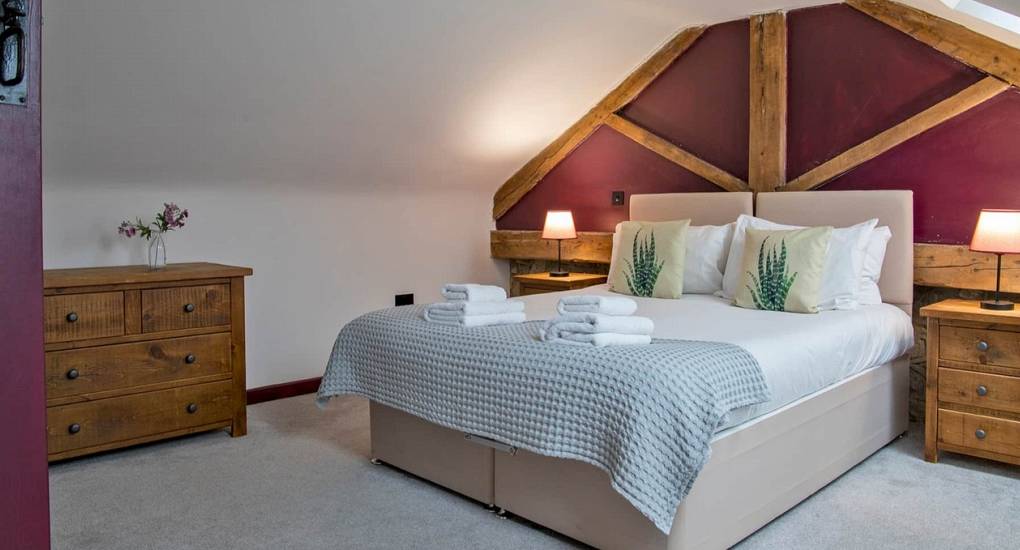 Luxury double bedroom with traditional features at Lathkill Escape Peak District hen party stay.