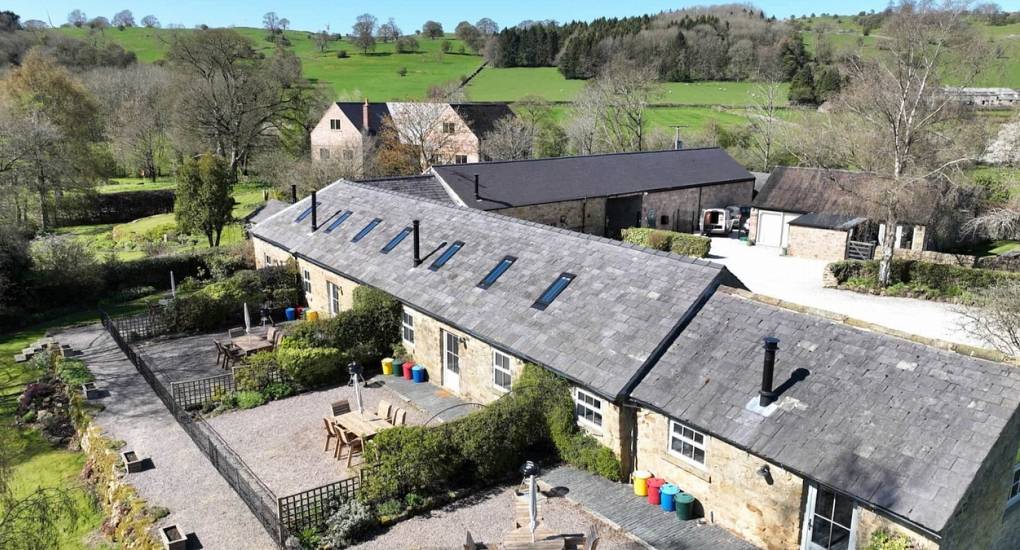 Exterior view of the linked luxury hen cottages at Lathkill Escape, set in the Derbyshire Peak District.