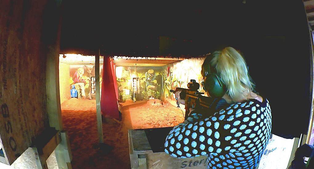 Young woman on a hen party shooting at targets