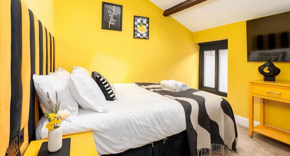 Spacious twin bedroom with bold decor and artwork at the Mountaintop Marvel party house