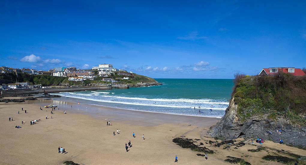 Sandy Towan Beach and rock island house in Newquay Cornwall, sunny coastal backdrop for a Newquay hen do.