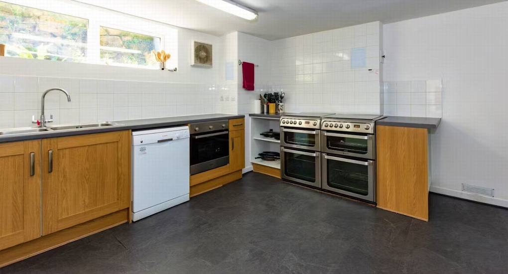 A second view of the kitchen area at Ross Lodge Gloucestershire, highlighting the double ovens and cooking amenities for this Gloucestershire hen do accommodation.